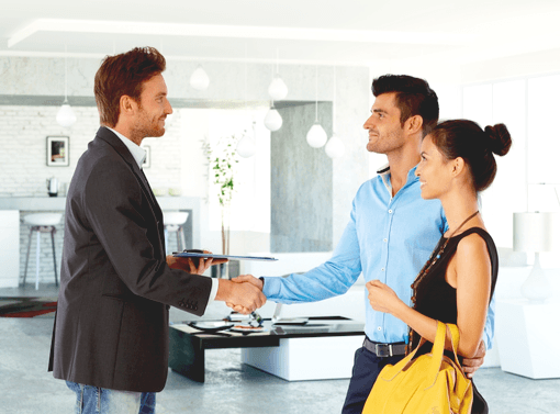 Estate agent shows prospective buyers around the house